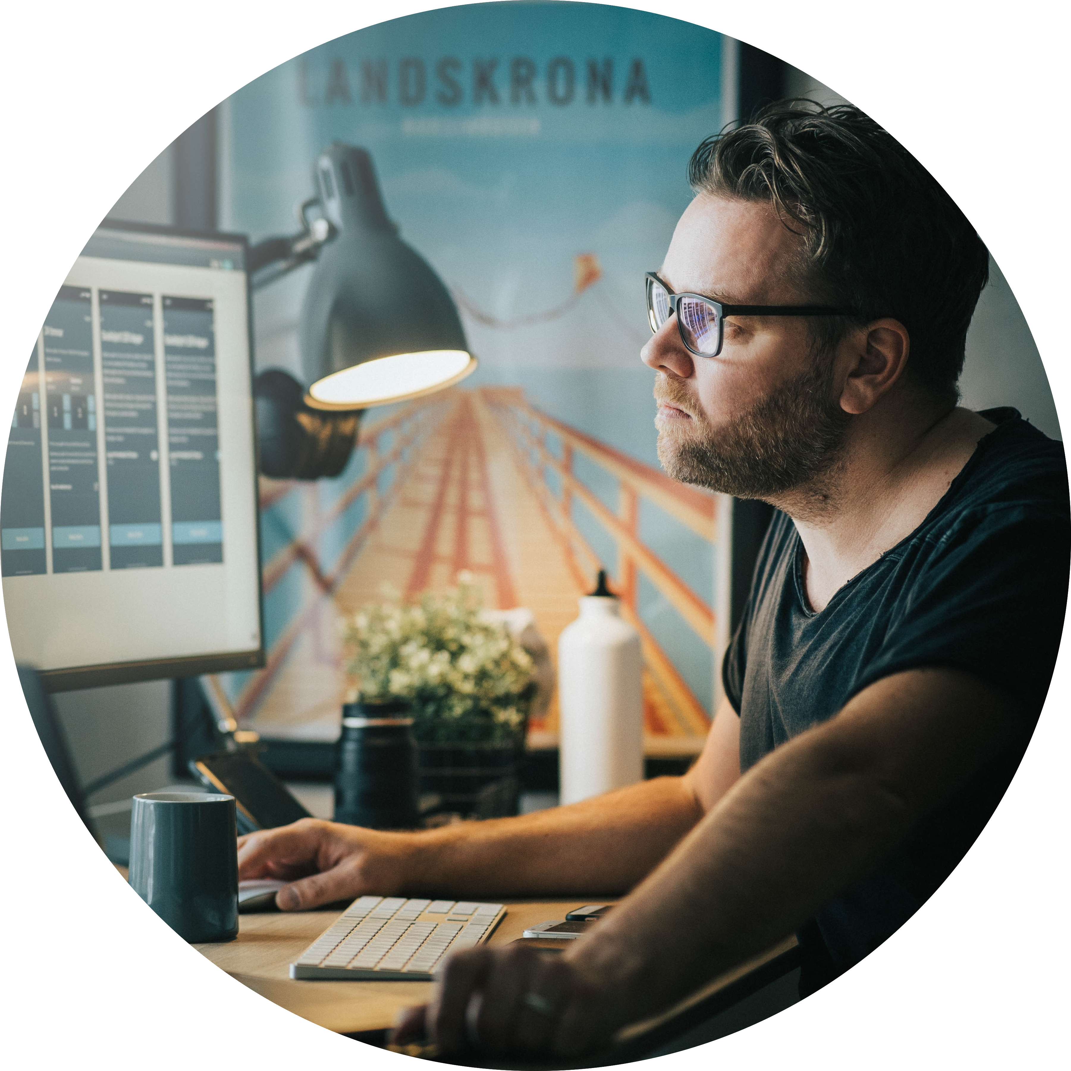 A man with glasses stares pensively at his computer screen